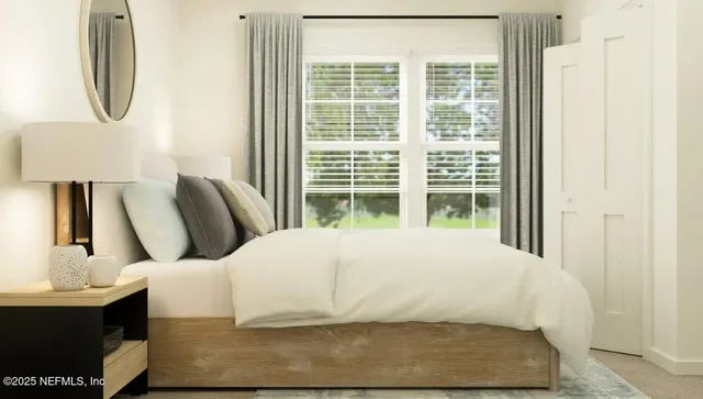 a bed sitting in a bedroom next to a window