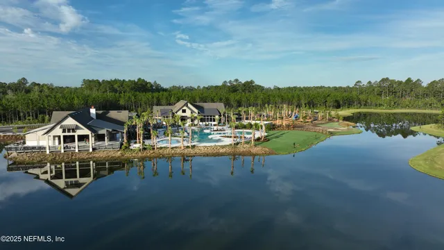 a view of a house with yard and lake view