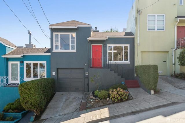a front view of a house with outdoor seating