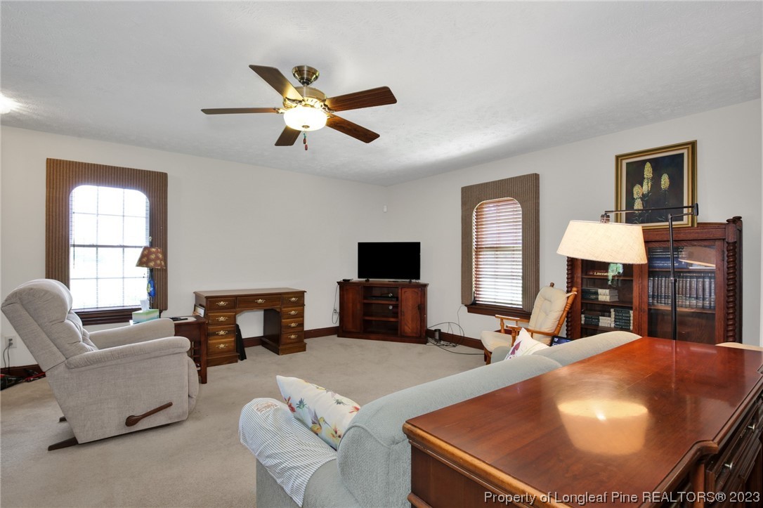 6015 Goldsboro Road Wade, NC 28395 - Photo 12 of 50 a living room with furniture and a flat screen tv