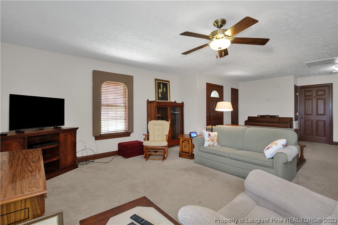 6015 Goldsboro Road Wade, NC 28395 - Photo 17 of 50 a living room with furniture and a flat screen tv