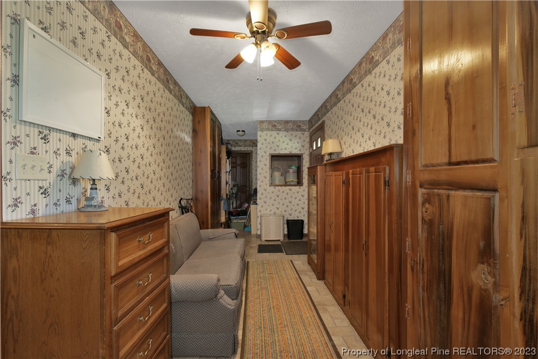 6015 Goldsboro Road Wade, NC 28395 - Photo 27 of 50 a view of a hallway with furniture and chandelier