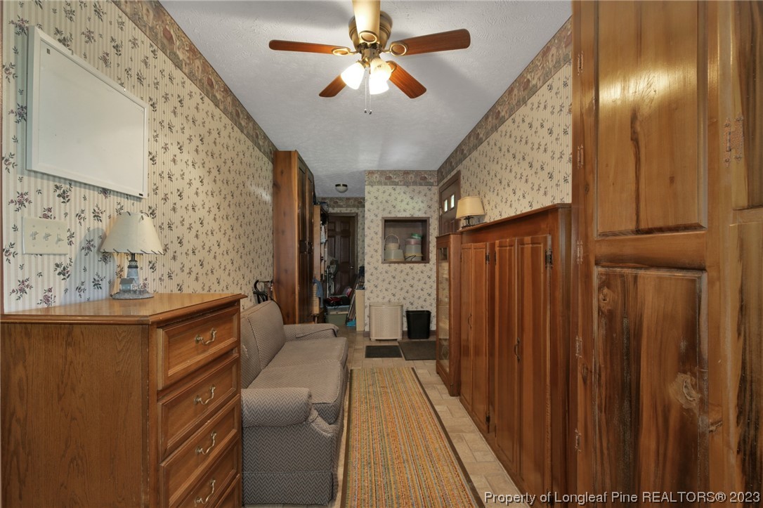 6015 Goldsboro Road Wade, NC 28395 - Photo 28 of 50 a view of a hallway with furniture and chandelier