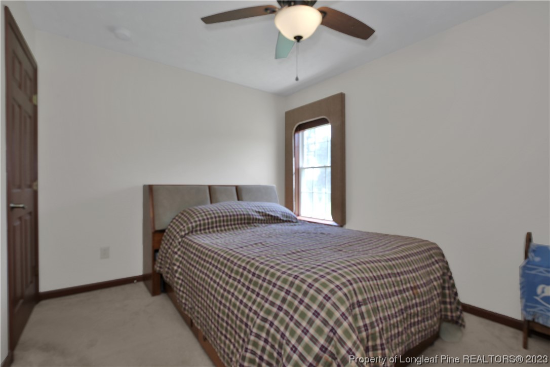 6015 Goldsboro Road Wade, NC 28395 - Photo 35 of 50 a bedroom with a bed and window