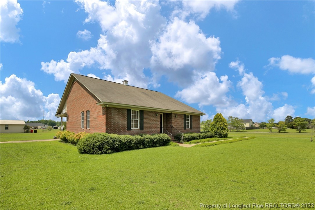 6015 Goldsboro Road Wade, NC 28395 - Photo 4 of 50 a front view of house with yard and trees