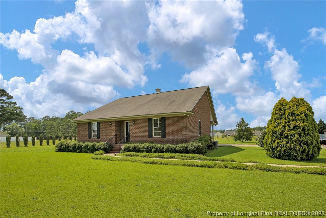 6015 Goldsboro Road Wade, NC 28395 - Photo 5 of 50 a front view of a house with garden
