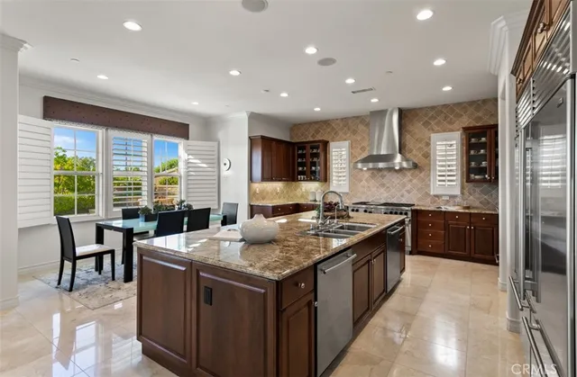 a kitchen with kitchen island granite countertop a stove and a large window
