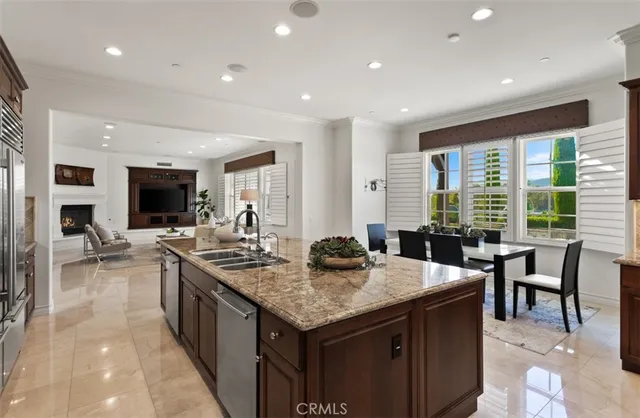 a kitchen with stainless steel appliances granite countertop a stove a sink and a refrigerator