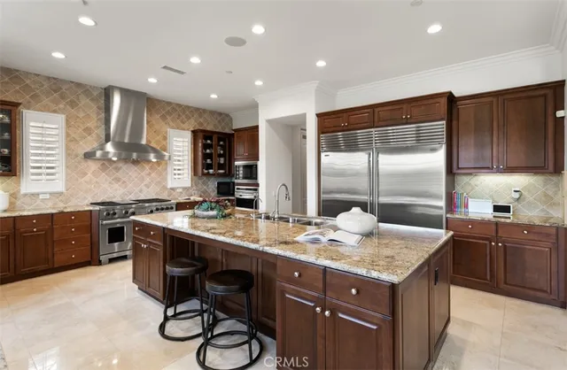 a kitchen with stainless steel appliances granite countertop a sink and a wooden cabinets