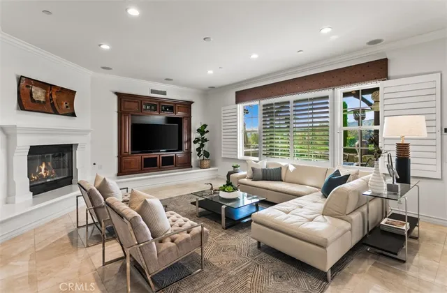 a living room with furniture a window and a flat screen tv