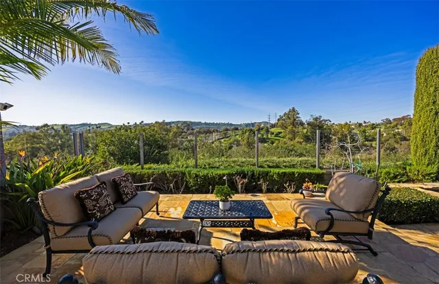 a view of a house with backyard and sitting area