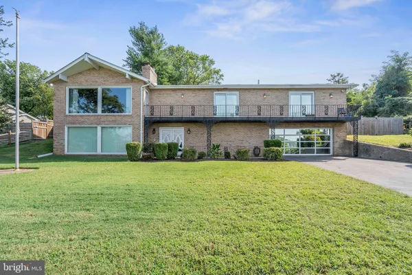 a kitchen with stainless steel appliances granite countertop a refrigerator a oven a sink and a dining table