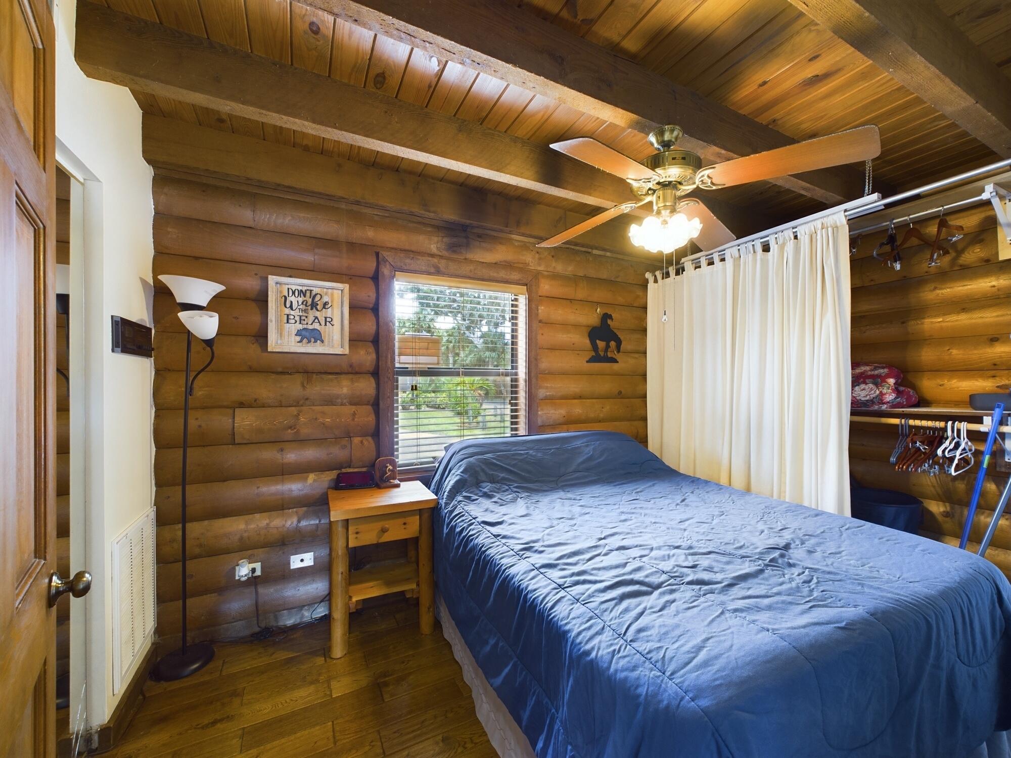 8348 Highway 441 Okeechobee, FL 34974 - Photo 18 of 25 a bedroom with a bed and a flat tv screen