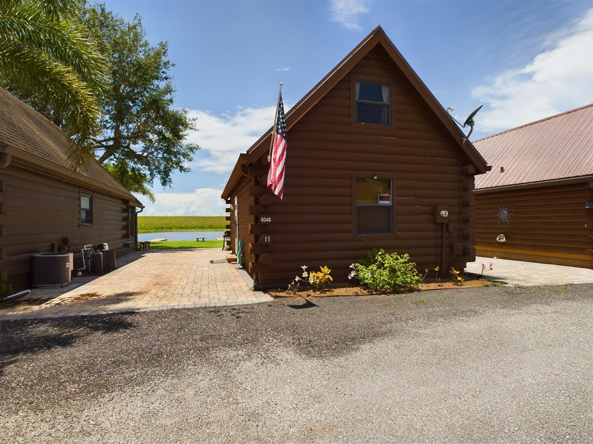8348 Highway 441 Okeechobee, FL 34974 - Photo 3 of 25 a view of a house with a yard and garage