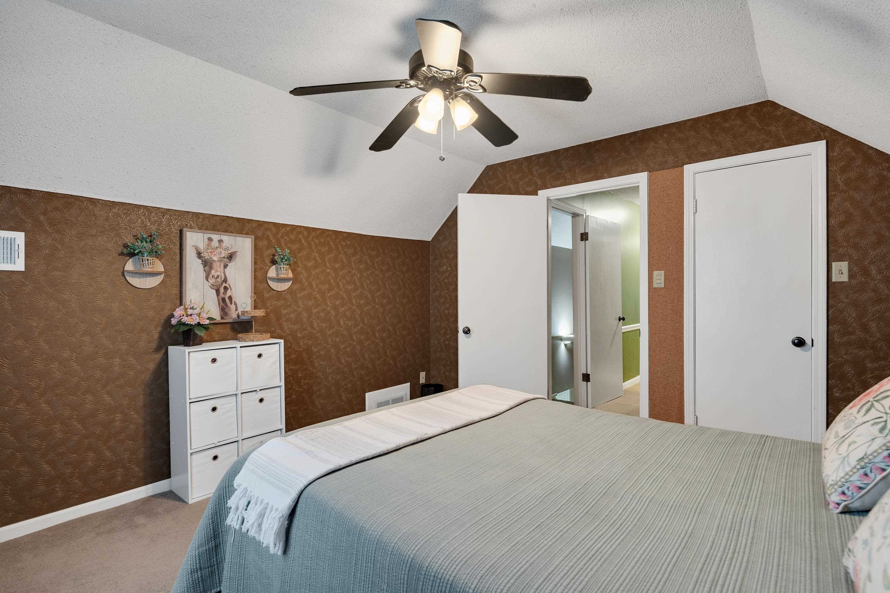 6125 Pleasant Ridge Road Millington, TN 38053 - Photo 17 of 40 a bedroom with a bed and a chandelier