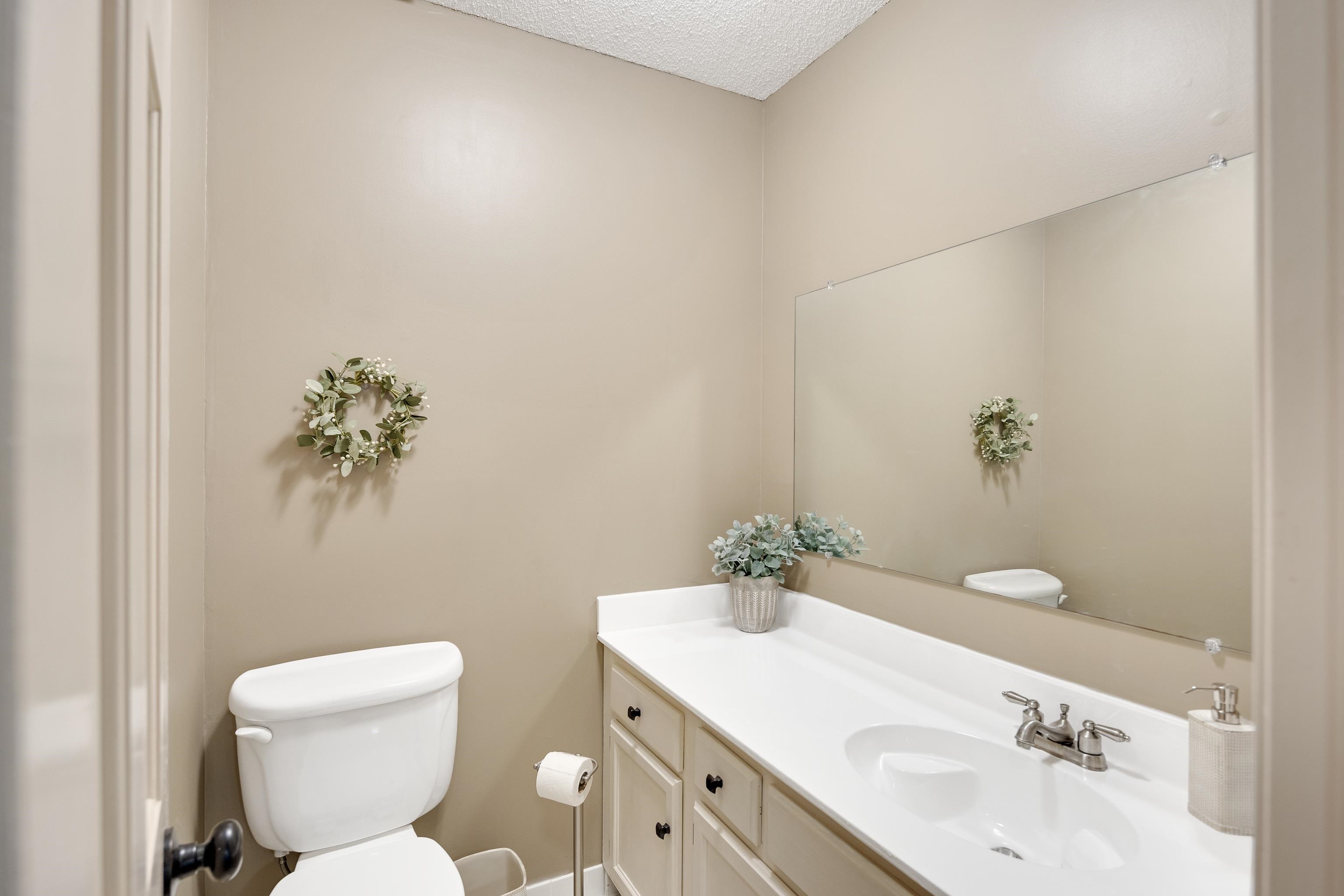 6125 Pleasant Ridge Road Millington, TN 38053 - Photo 18 of 40 a bathroom with a toilet sink and mirror