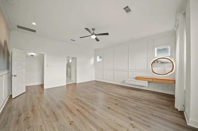 a view of a room with wooden floor and white walls