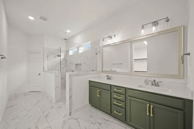 a bathroom with a shower sink double and mirror