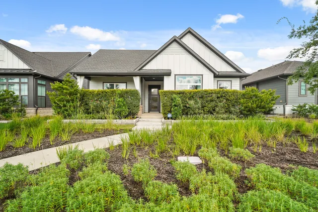 a view of a house with garden and yard