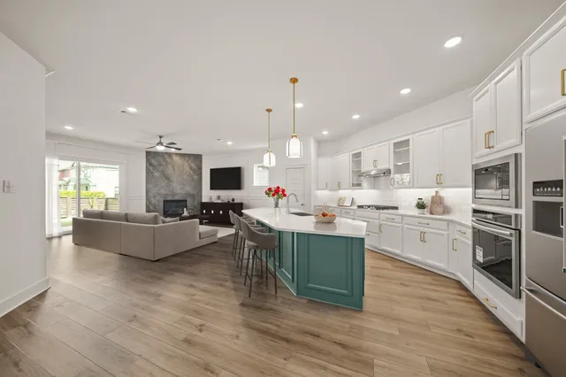 a large kitchen with stainless steel appliances lots of counter top space