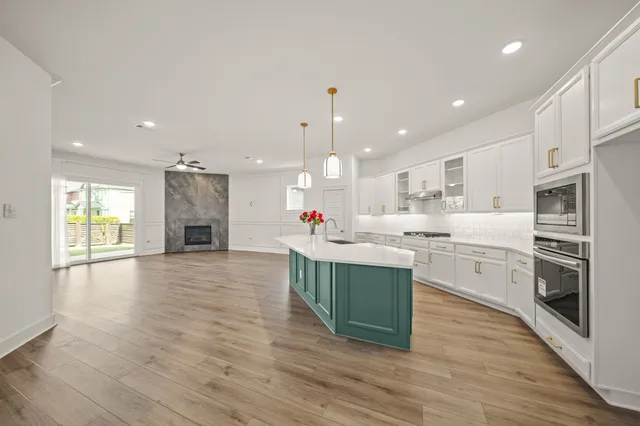 a large kitchen with stainless steel appliances kitchen island granite countertop a large counter top and stove top oven