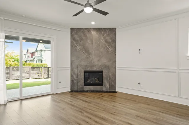 wooden floor fireplace and natural light in room