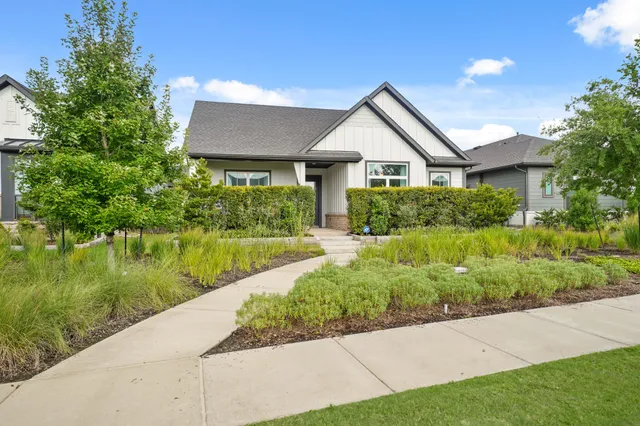 a view of house with garden and a pond