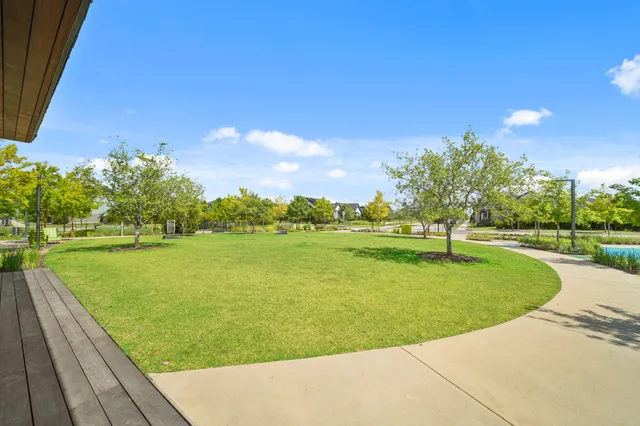 a view of a swimming pool and trees in the background