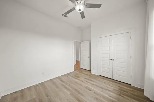 a view of an empty room and wooden floor