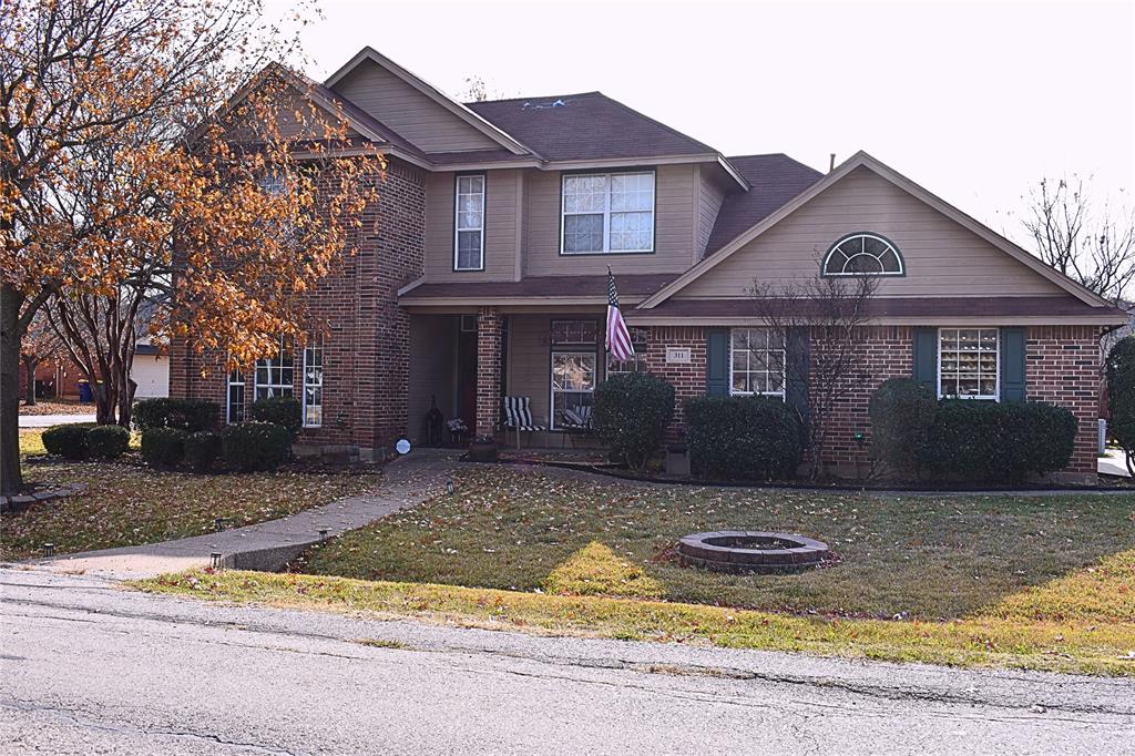 a front view of a house with a yard garage and sitting area