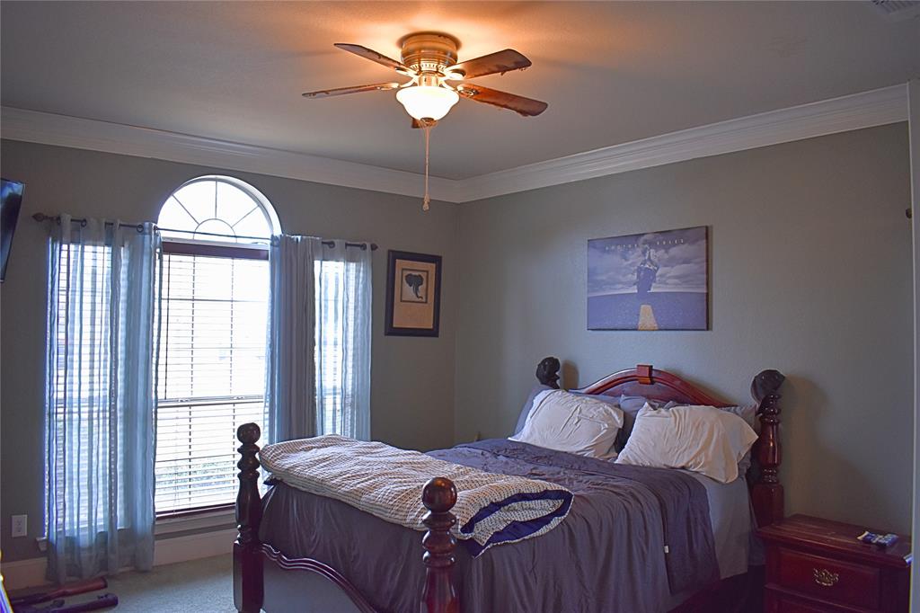 311 Ridge Hollow Trail Venus, TX 76084 - Photo 11 of 38 a bedroom with a bed and a chandelier