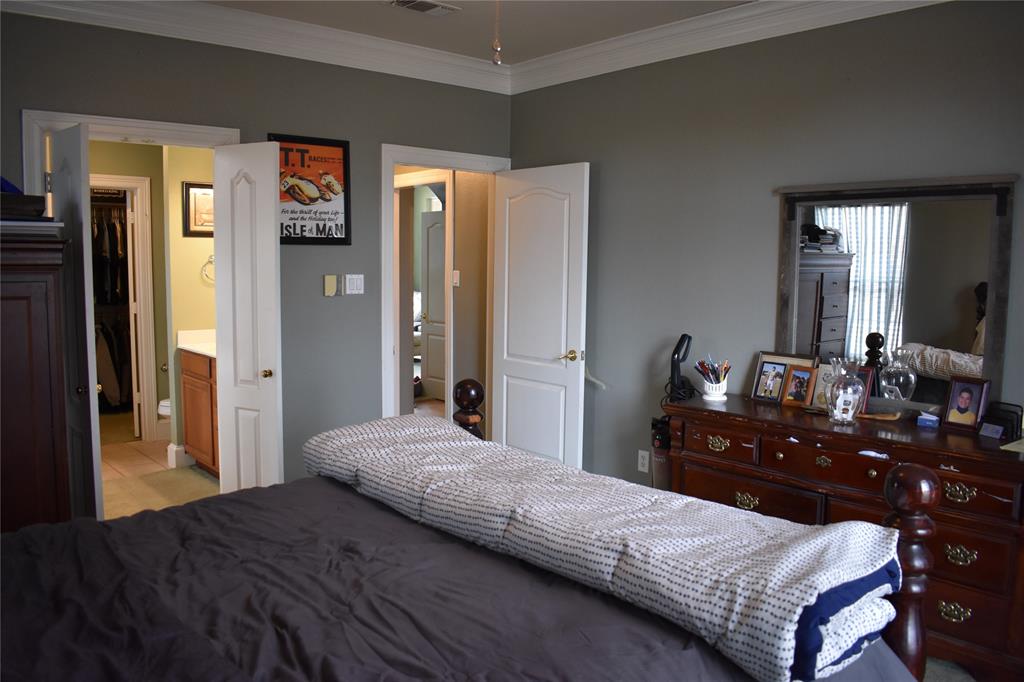 311 Ridge Hollow Trail Venus, TX 76084 - Photo 13 of 38 a bedroom with a bed and a dresser
