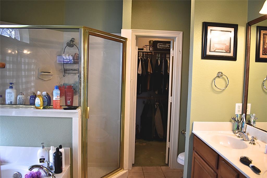 311 Ridge Hollow Trail Venus, TX 76084 - Photo 14 of 38 a bathroom with a sink a mirror and a shower