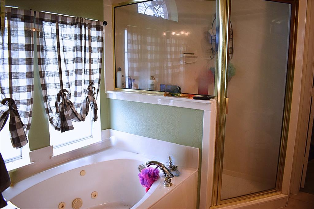 311 Ridge Hollow Trail Venus, TX 76084 - Photo 15 of 38 a bathroom with a bathtub and a shower