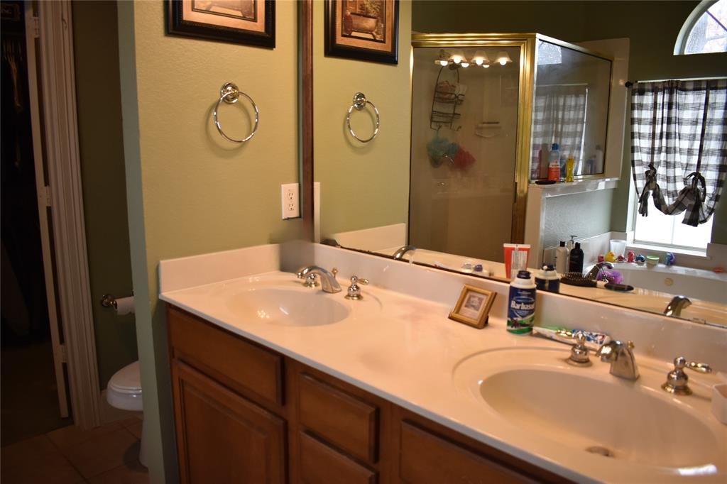 311 Ridge Hollow Trail Venus, TX 76084 - Photo 16 of 38 a bathroom with a granite countertop sink and a mirror