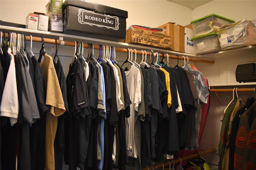 311 Ridge Hollow Trail Venus, TX 76084 - Photo 17 of 38 a view of walk in closet with clothes and shoes