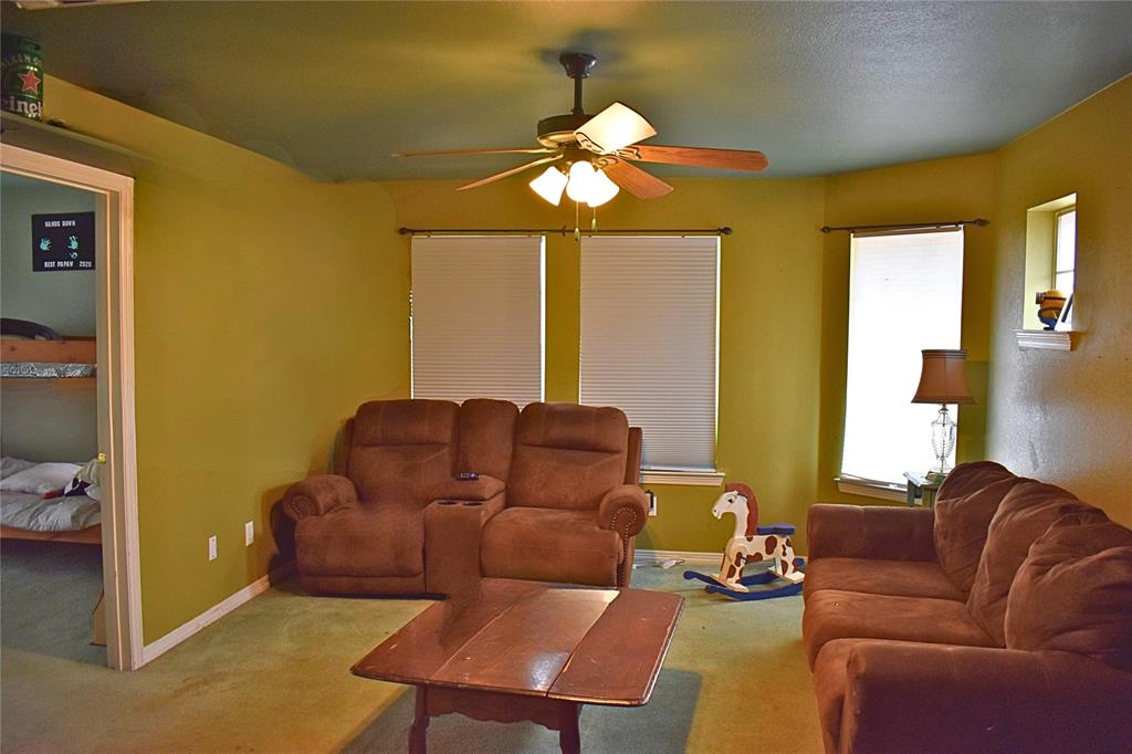 311 Ridge Hollow Trail Venus, TX 76084 - Photo 21 of 38 a living room with furniture a chandelier and a window