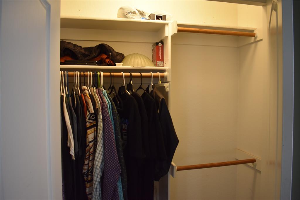 311 Ridge Hollow Trail Venus, TX 76084 - Photo 23 of 38 a view of walk in closet with clothes and shoes