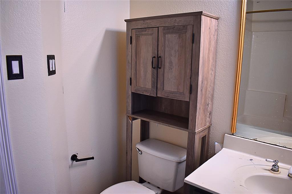 311 Ridge Hollow Trail Venus, TX 76084 - Photo 25 of 38 a bathroom with a toilet sink and mirror