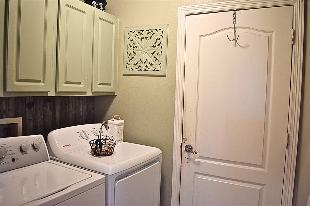 311 Ridge Hollow Trail Venus, TX 76084 - Photo 26 of 38 a kitchen with a refrigerator and cabinets