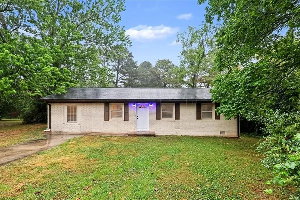 a front view of house with yard and trees