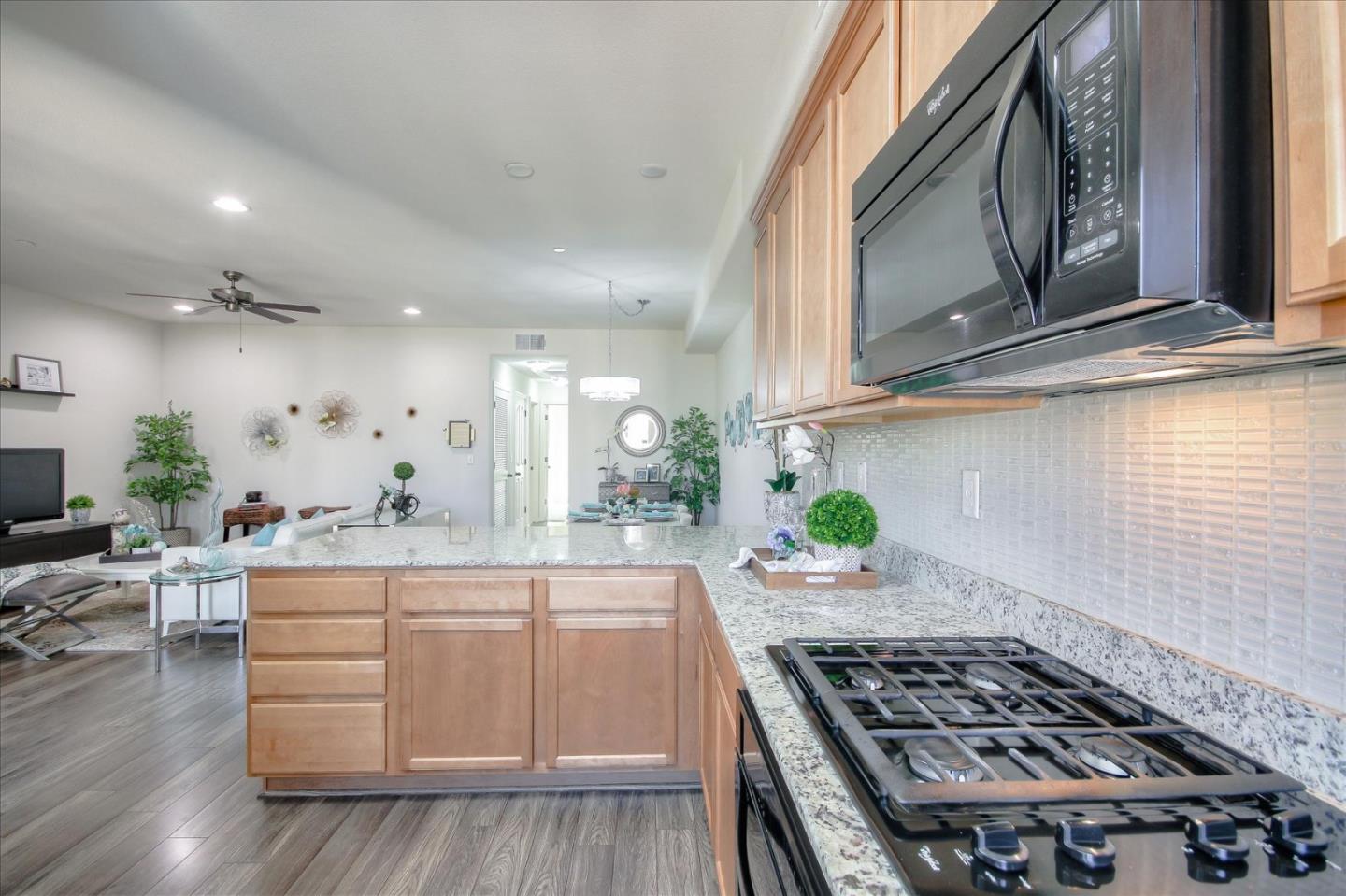 4712 Norris Canyon Road, Unit 202 San Ramon, CA 94583 - Photo 12 of 30 a kitchen with stainless steel appliances granite countertop a stove a sink and a microwave