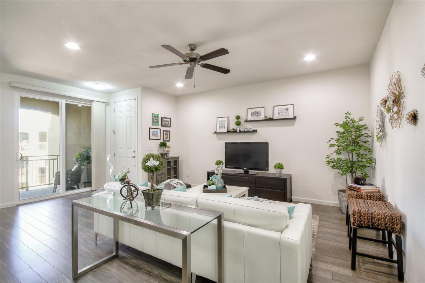 4712 Norris Canyon Road, Unit 202 San Ramon, CA 94583 - Photo 2 of 30 a living room with furniture a fireplace and a potted plant