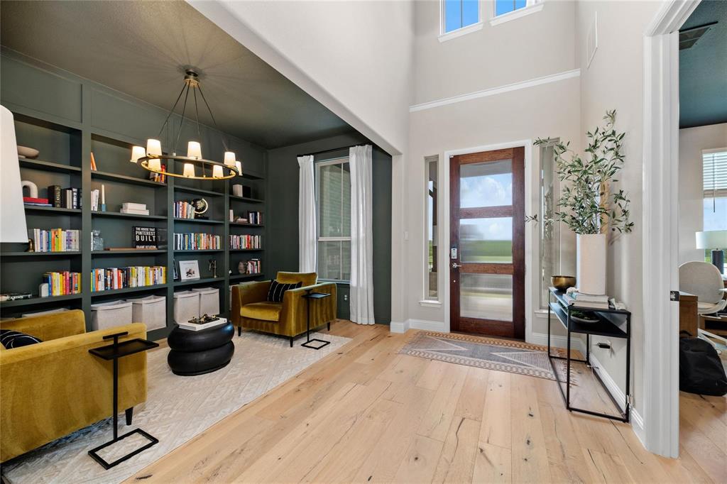 2262 Poppyvine Road Frisco, TX 75033 - Photo 11 of 40 a view of a workspace with furniture and a book shelf