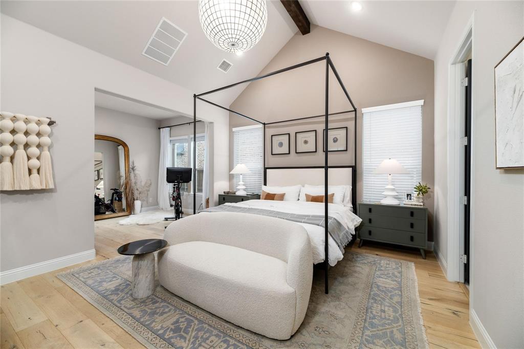 2262 Poppyvine Road Frisco, TX 75033 - Photo 16 of 40 a bedroom with a bed and a chandelier