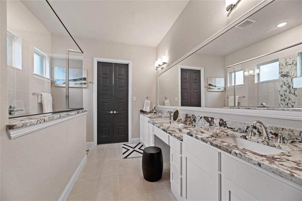 2262 Poppyvine Road Frisco, TX 75033 - Photo 20 of 40 a bathroom with a sink and a mirror