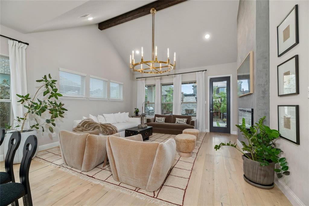 2262 Poppyvine Road Frisco, TX 75033 - Photo 3 of 40 a living room with furniture and a chandelier