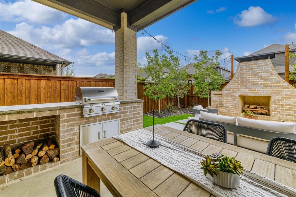 2262 Poppyvine Road Frisco, TX 75033 - Photo 40 of 40 a view of a patio with couches chairs potted plants and a palm tree