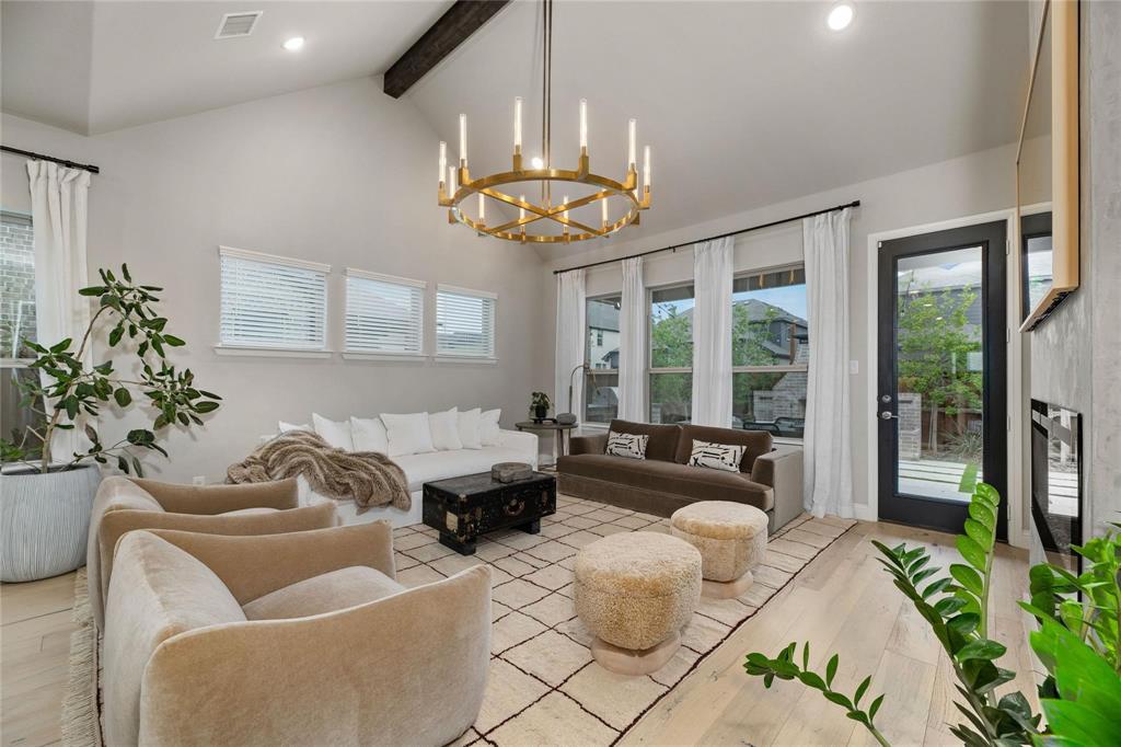 2262 Poppyvine Road Frisco, TX 75033 - Photo 4 of 40 a living room with furniture and a chandelier