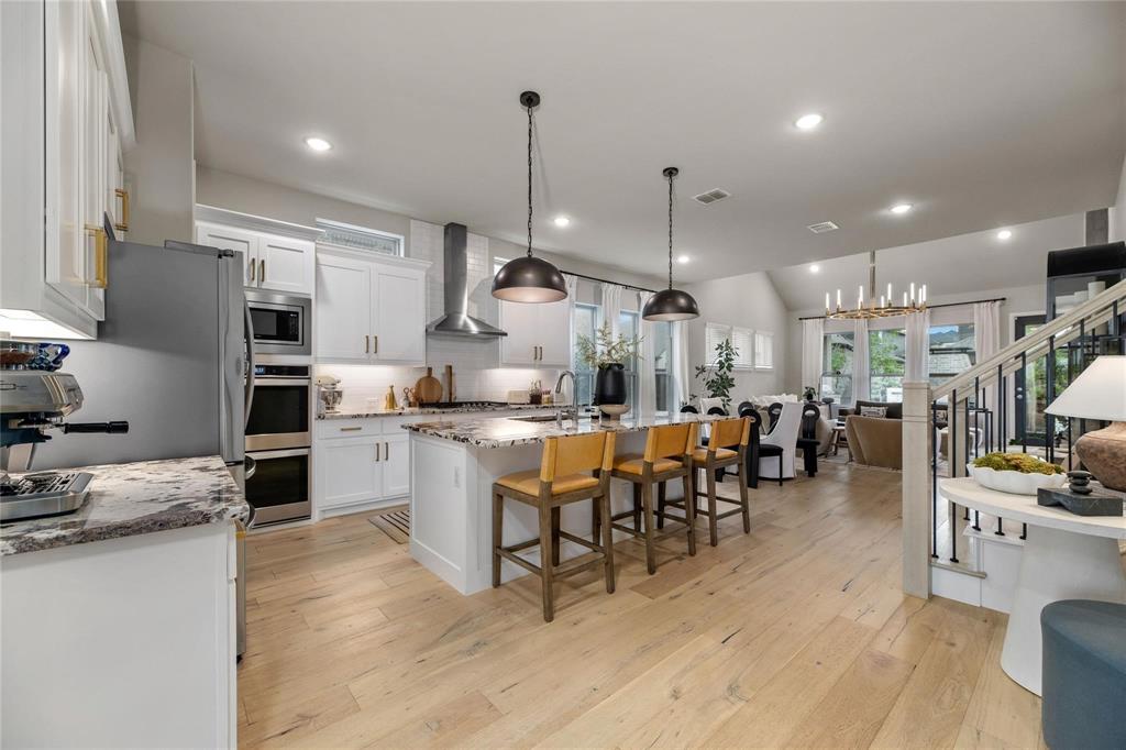 2262 Poppyvine Road Frisco, TX 75033 - Photo 5 of 40 a kitchen with lots of counter top space and stainless steel appliances